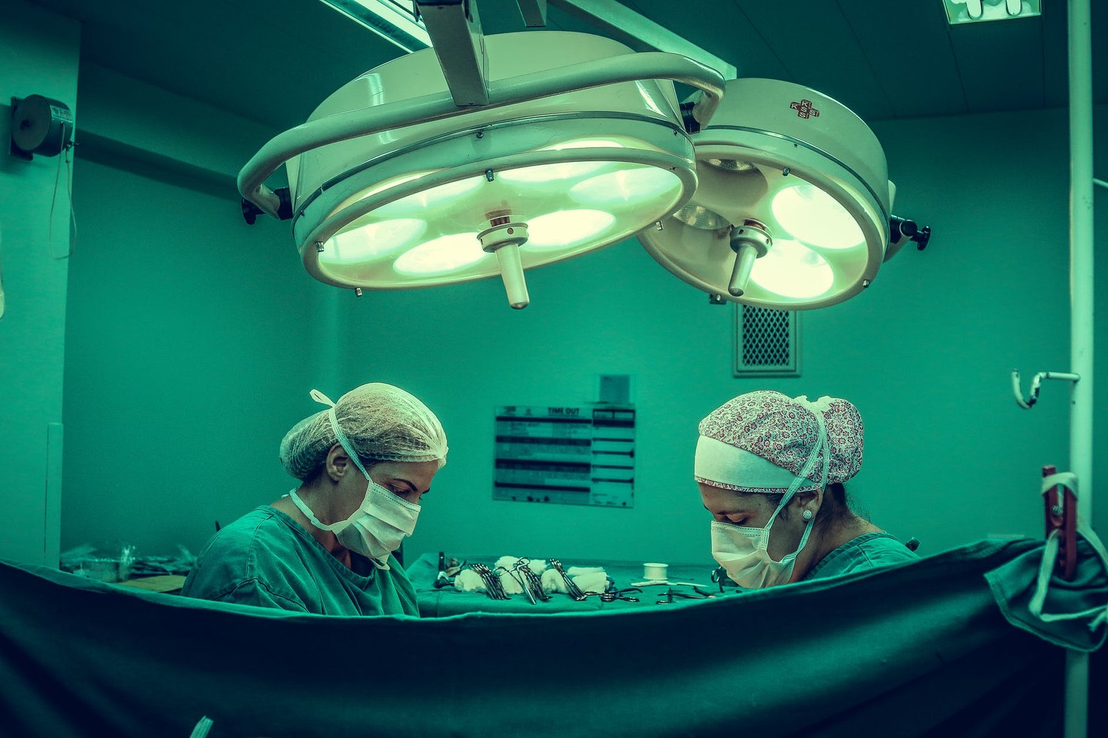 two person doing surgery inside room