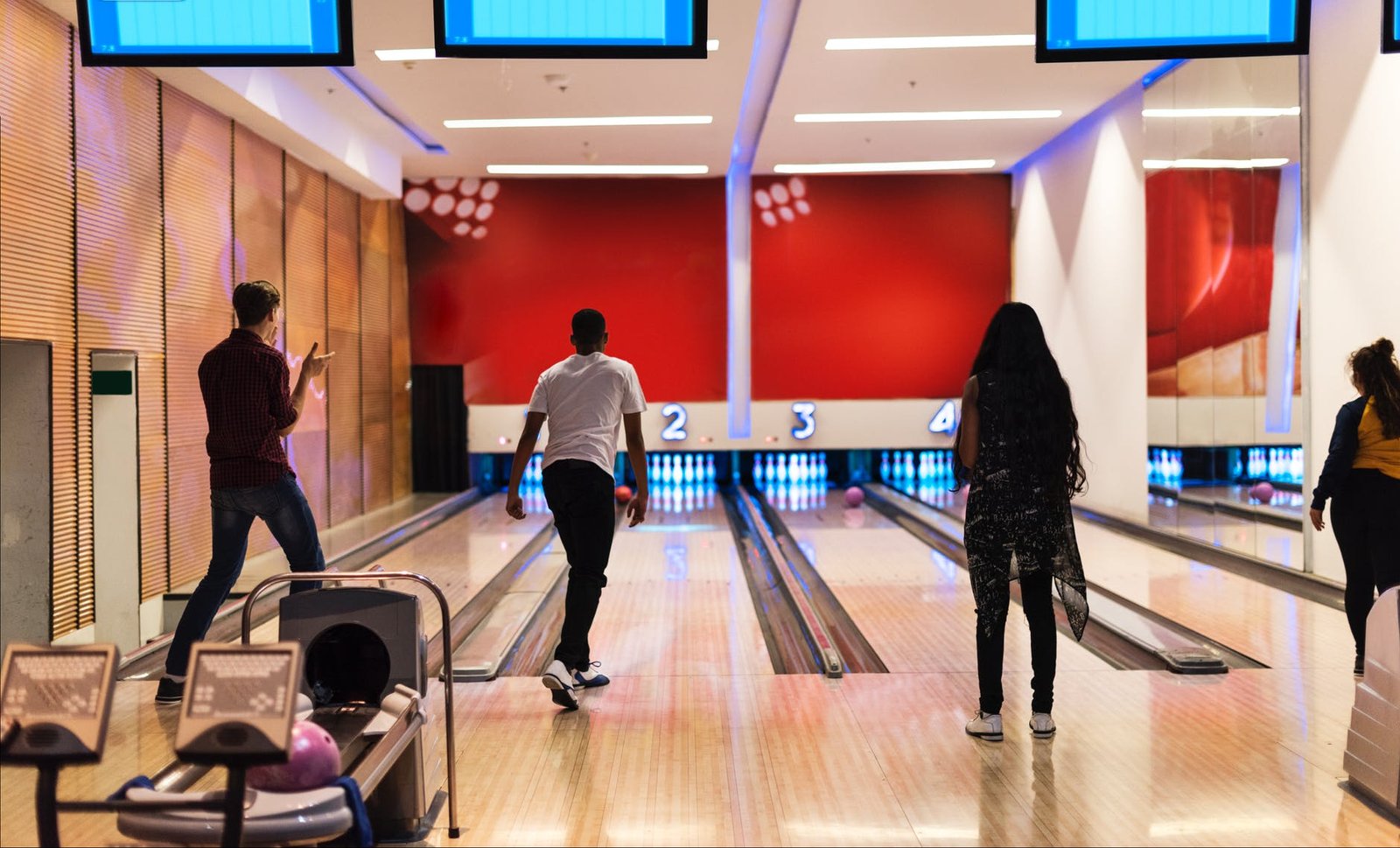 men and women playing bowling
