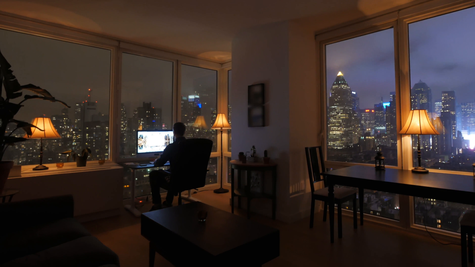 one-person-working-at-home-in-modern-city-apartment-loft-at-night_rgmg0lfxr__F0004