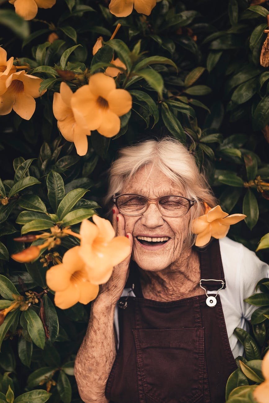 woman standing near yellow petaled flower