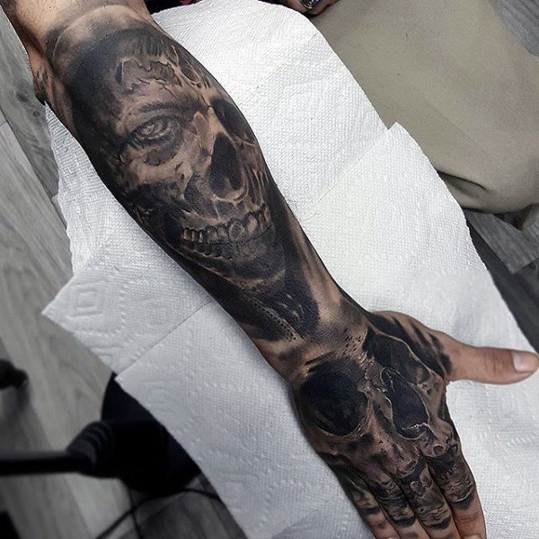 man-with-skull-and-zombies-lower-forearm-tattoo-sleeves